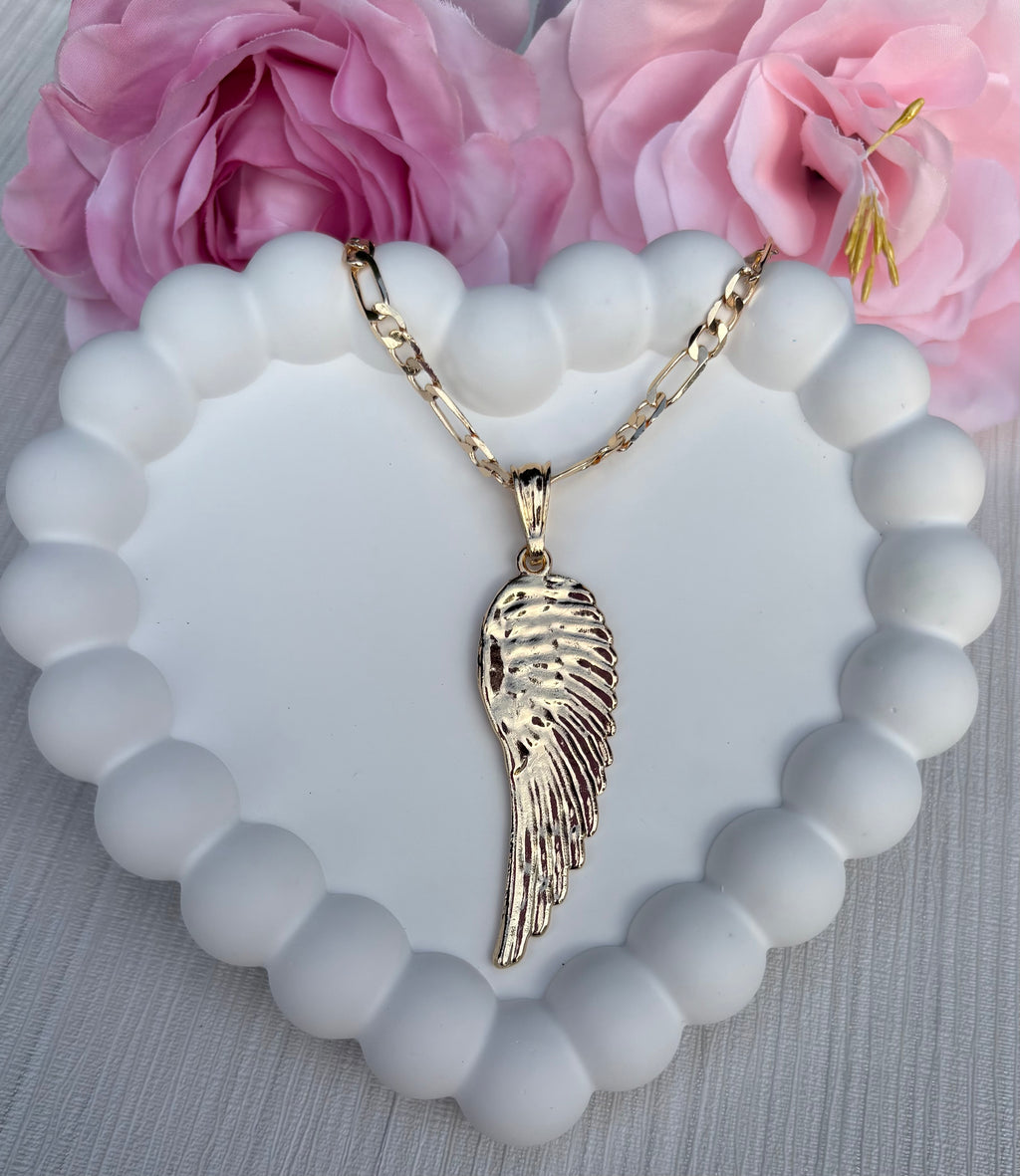 Gold angel wing necklace displayed on white background, featuring delicate chain and shiny wing pendant.