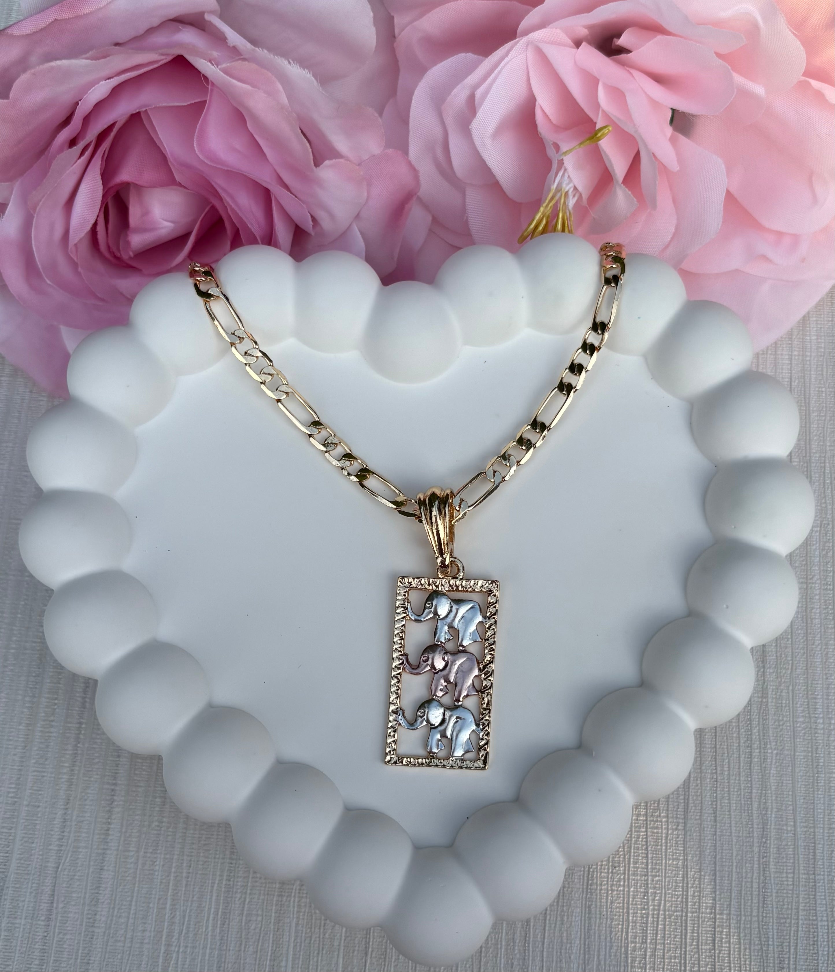 Elephant Harmony Necklace with three elephants in gold, pink, and silver on a gold chain, displayed on white background.