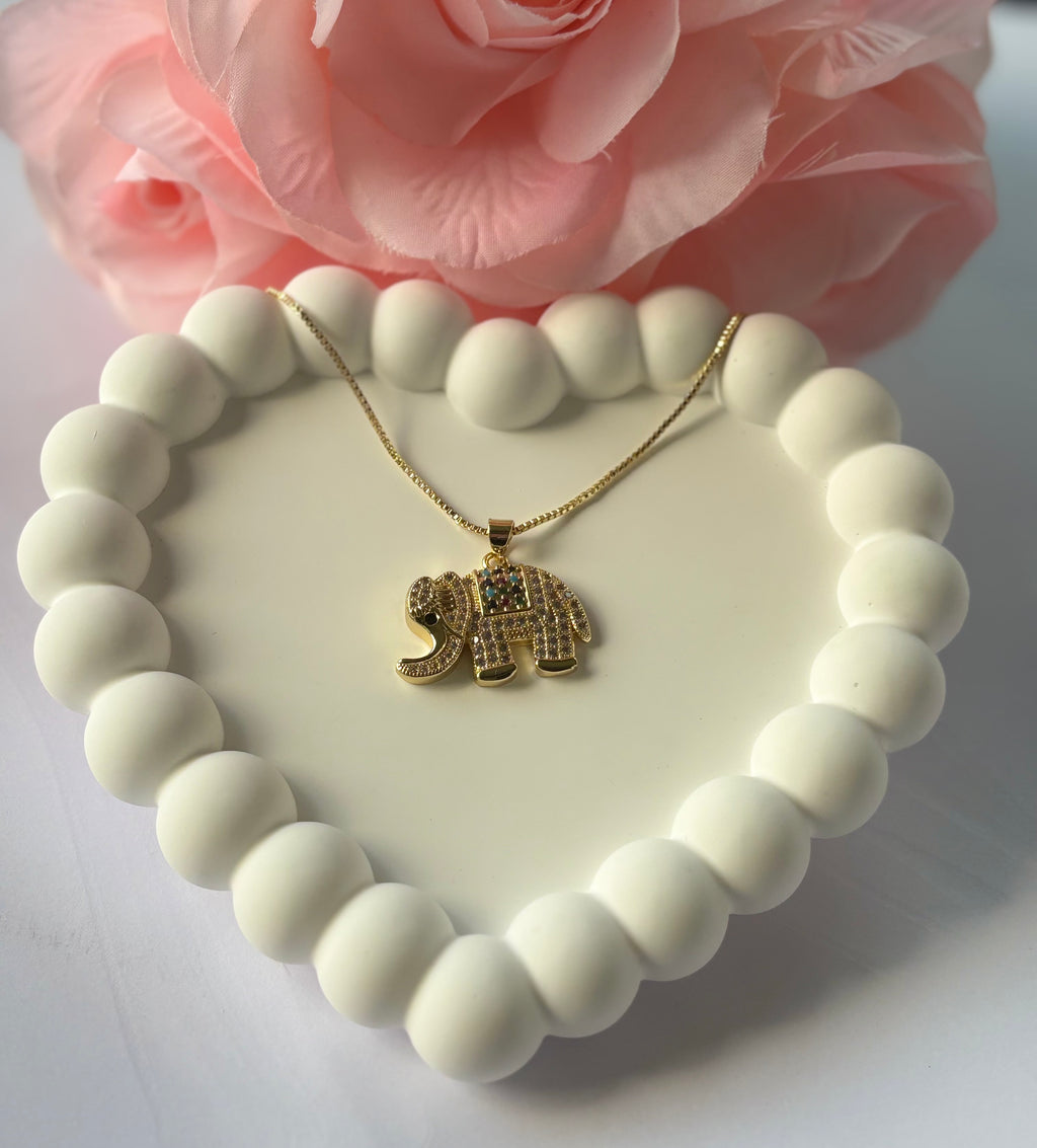 Icy Elephant Necklace with gold-plated chain and rhinestone-covered elephant pendant, displayed on white background.